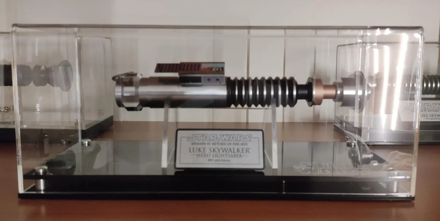 Review of Custom Sized Display Case with a Modern Base (Choice of Base Colours) by Enrico Nascimben Photo of the custom sized acrylic display case with a Star Wars light saber inside.