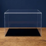 Main image of the custom sized acrylic display case with a black low profile base, on an oak table in front of a dark blue background