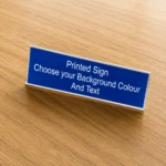 Front view of the Printed Acrylic Sign, shown on a wooden table