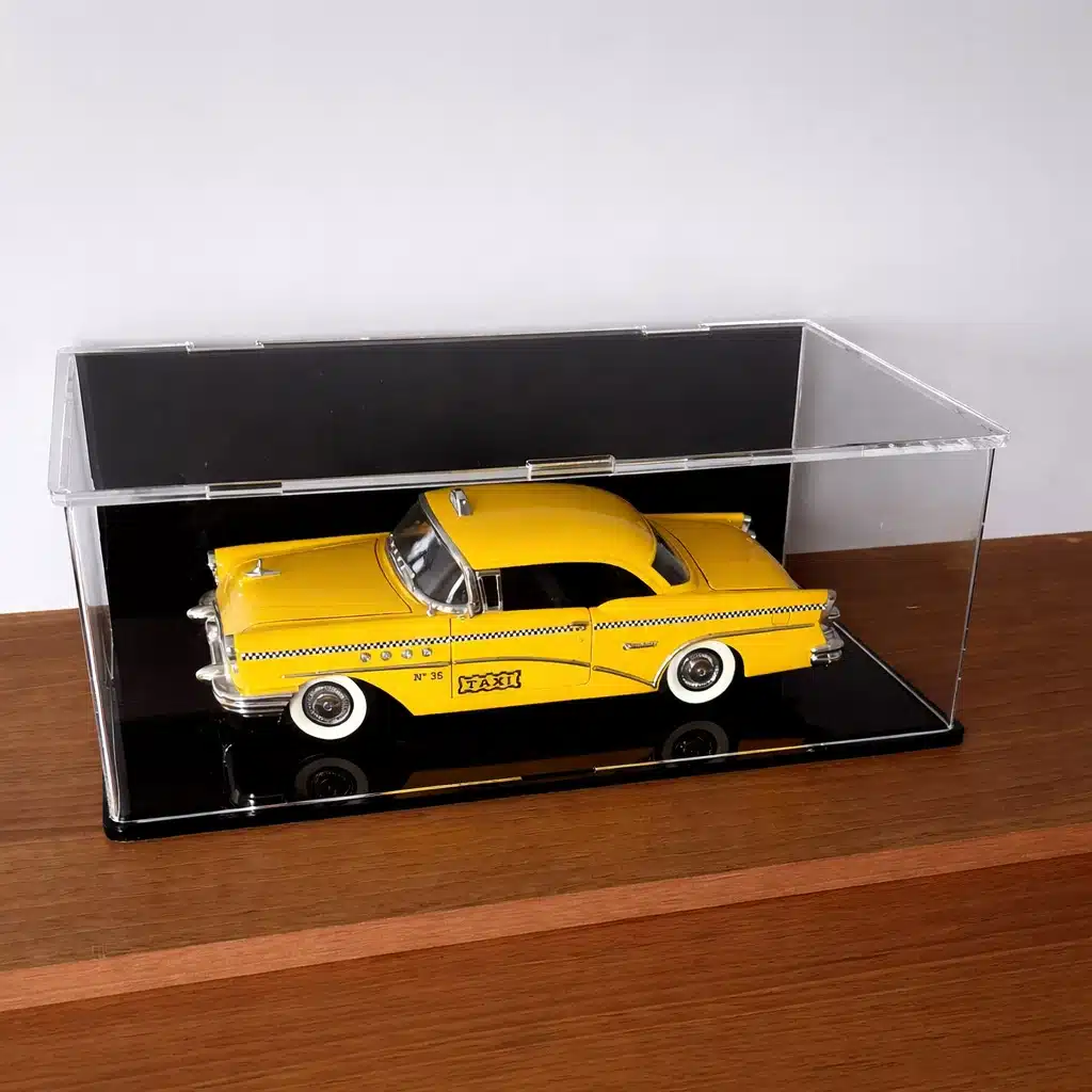 1:18 Scale Model Car Stackable Display case, shown with a black base and a black back, contains a yellow US taxi.