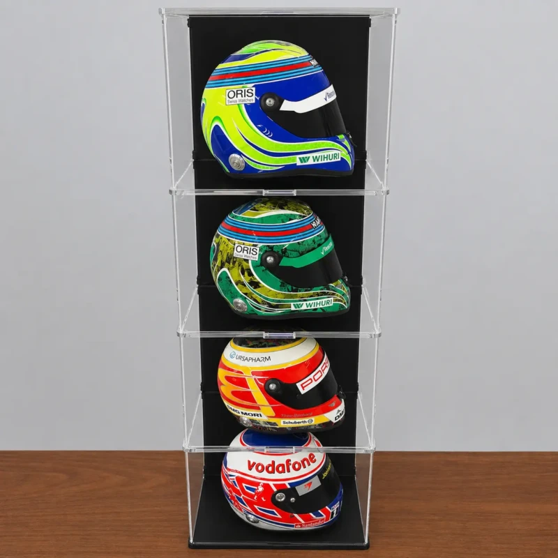 Image showing the display case with 3 additional layers, shows a total of 4 levels, each with a 1:2 scale model F1 helmet inside, shown on a wooden table in front of a grey wall