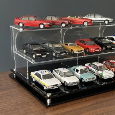 Image of the 1:43 scale model car display case , showing just the base and stand with the acrylic cover removed, on a grey background